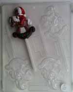 Bear in Santa cap sitting on rocking horse Lollipop C122